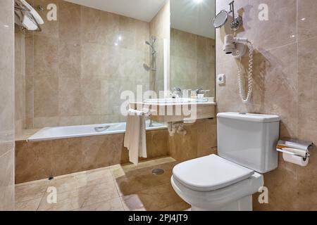 Das Badezimmer des Krankenhauses ist mit Marmor verziert. Dusche, Toilette, Handwaschbecken Stockfoto