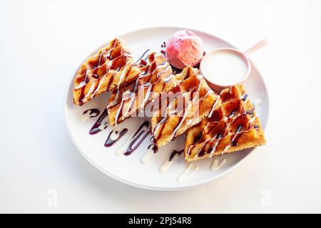 Belgische Waffeln, Schokolade und Vanille mit Erdbeereis. Stockfoto