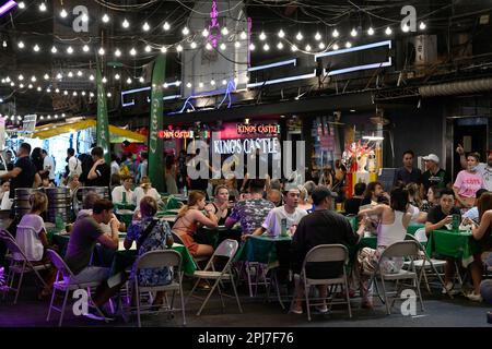 Bangkok, Thailand. 30. März 2023. Eine allgemeine Ansicht der Kunden, die lokale Street Food essen. Bangkoks berüchtigtes Rotlicht-Unterhaltungsviertel Patpong wurde seit der COVID-19-Pandemie wieder eröffnet. Es ist wieder ein Street Food Nachtmarkt mit nur wenigen Go Go Go Bars, 2 Straßen bieten auch Souvenirs, Kleidung und Schmuck. Seit der Legalisierung von Marihuana am 9. Juni wurden auch Marihuana-Verkaufsstellen in der Region eröffnet. (Credit Image: © Paul Lakatos/SOPA Images via ZUMA Press Wire) NUR ZUR REDAKTIONELLEN VERWENDUNG! Nicht für den kommerziellen GEBRAUCH! Stockfoto