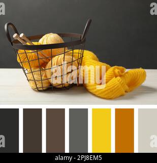 Weiches gelbes Wollgarn mit Stricknadeln und Pullover auf weißem Tisch. Komposition inspiriert von den Farben des Jahres 2021 Stockfoto