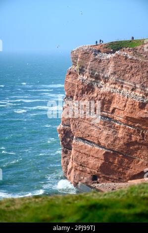 24. März 2023, Schleswig-Holstein, Helgoland: Wanderer stehen auf den Guillemot-Felsen auf der Hochseeinsel Helgoland. Foto: Jonas Walzberg/dpa Stockfoto