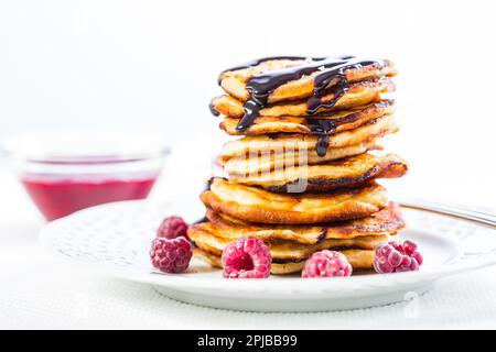 Köstliche Pfannkuchen mit Himbeeren und Schokoladensaft. Frikadellen Stockfoto