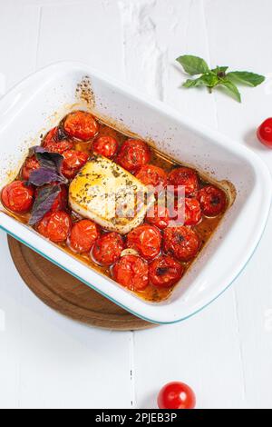 Fetapasta. Trending viralen Feta backen Pasta Rezept aus Kirschtomaten, Feta-Käse, Knoblauch und Kräuter in einer Auflaufform. Stockfoto