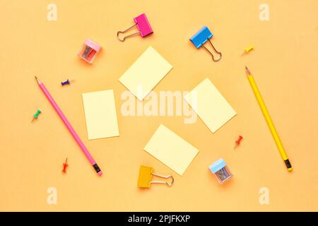 Haftnotizen, Bleistift und Stifte auf gelbem Hintergrund Stockfoto