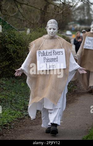 Little Marlow, Buckinghamshire, Großbritannien. XR Penitents hat heute in Buckinghamshire vor der Themse gegen das Wasser der Themse protestiert und gegen die Abwasserentsorgung der Themse protestiert. Die Geisterfiguren der Penitents gingen von den Abwasserwerken zur Themse und trugen Sündenplakate, um die Öffentlichkeit für Abwasserableitungen zu sensibilisieren. Umweltministerin Thérèse Coffey hat angekündigt, dass Wasserunternehmen unbegrenzte Geldstrafen für verschmutzende Flüsse erhalten werden, doch viele Umweltschützer sind der Meinung, dass dies nicht weit genug geht und dass der Rückzug erfolgt Stockfoto