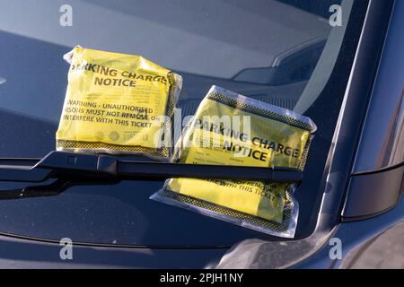 Hinweis an den Fahrer, dass die Parkgebühren (PCN) auf einer Windschutzscheibe in England angegeben sind. Konzept: Unfaire Parkgebühren, ansprechendes Parken in Ordnung Stockfoto