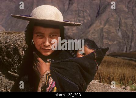 Frau aus der ethnischen Gruppe Quechua und ihr Baby in einem Dorf Ayata, Departamento La Paz, Provincia Munecas in den bolivianischen Anden. Stockfoto