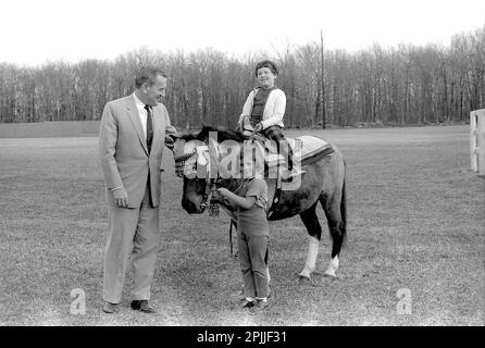 KN-27637 31. März 1963 Sally Fay Reitpferd „Macaroni“ unter der Leitung von Paul „Red“ Fay und Caroline Kennedy. „Macaroni“ trägt einen marokkanischen Sattel, den König Hassan II. Von Marokko den Kennedys gegeben hat. Camp David, Maryland. Bitte schreiben Sie Robert Knudsen. Fotos Vom Weißen Haus. John F. Kennedy Presidential Library and Museum, Boston“ Stockfoto