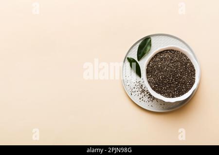 Chia Samen in Schale auf farbigem Hintergrund. Gesunde Salvia hispanica in kleiner Schüssel. Gesundes Superfood. Stockfoto