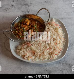 Indische Dishe kulinarisches Still Life. Hähnchen Tikka Massala serviert mit Reis auf einem Teller Stockfoto