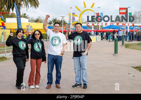 IMAGE DISTRIBUTED FOR MOVEMENT CATALYST Starbucks workers pose in front of LEGOLAND in Carlsbad CA where they distributed leaflets and released a short animated film on a mobile billboard that circled