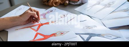 Eine gesichtslose Frau zeichnet Aquarelle von Sportbekleidung. Nahaufnahme der Hände eines Modedesigners. Stockfoto