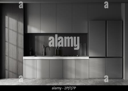 Inneneinrichtung der stilvollen Küche mit grauen und dunklen Holzwänden, Betonboden, grauen Schränken mit eingebautem Waschbecken und Herd und großem Kühlschrank. 3D-Rendering Stockfoto