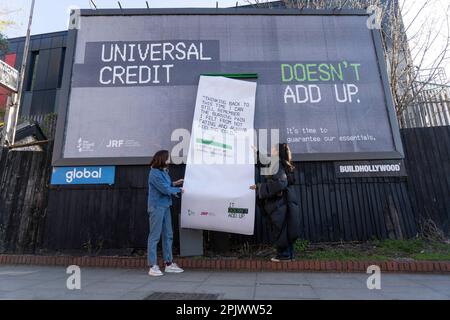 REDAKTIONELLER GEBRAUCH NUR der britische Schauspieler Charlotte Ritchie (links) und Sänger/Songwriter Joy Crookes reißen eine riesige Quittung von einer Plakatinstallation in der Nähe der U-Bahn-Station Finsbury Park in London ab, die vom Trussell Trust und der Joseph Rowntree Foundation im Rahmen ihrer „IT doesn't Add Up Campaign“ in Auftrag gegeben wurde. Mit dem Ziel, Probleme nach der Einführung des neuen Universal Credit AMOUNT hervorzuheben. Foto: Dienstag, 4. April 2023. Stockfoto