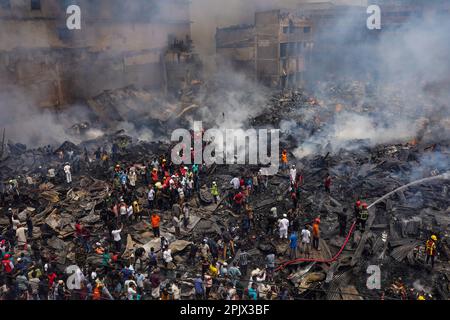 (ANMERKUNG DER REDAKTION: Bild mit einer Drohne aufgenommen) Luftaufnahme von Feuerwehrleuten, die versuchen, ein Feuer zu löschen, das in einem Bekleidungsmarkt in Dhaka ausbrach. Der Brand, der sich Anfang Dienstag in Dhakas Bangabazar Marknet ereignete, wurde nach über sechs Stunden hektischer Bemühungen unter Kontrolle gebracht. Geschäftsleute auf dem Gelände sagten, dass mindestens sechs Märkte in Bangabazar in Brand geraten seien. Davon gibt es nur den Bangabazar-Markt mit ca. 2.900 Geschäften und ca. 150.000 Personen, die dort arbeiten. Mindestens 48 Einheiten der Feuerwehr und des Zivilschutzes arbeiteten daran, das Feuer zu löschen. Stockfoto