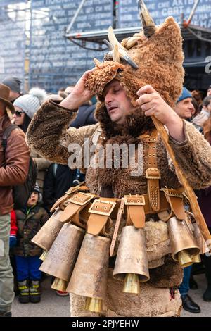 Müder männlicher Kukeri-Tänzer mit großen Glocken und Tierhautkostüm beim jährlichen Kukeri-Stadtfestival in Sofia, Bulgarien, Balkan, EU Stockfoto