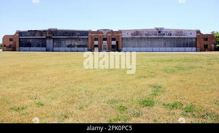 Floyd Bennett Field, grasbedeckter Flugplatz, verlassene Hangar mit Art déco-Elementen im Hintergrund, New York, NY, USA Stockfoto