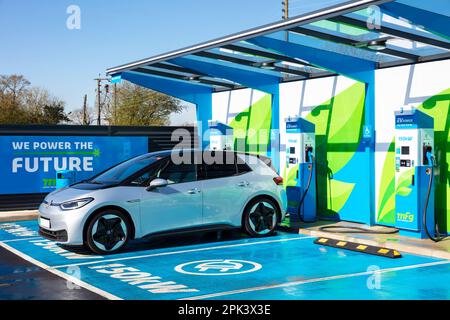 Electric Car UK – Aufladen eines Elektroautos bei einer Bank öffentlicher Ladegeräte für Elektroautos in einer MFG EV Power EV-Ladestation Elektrofahrzeug in Großbritannien Stockfoto