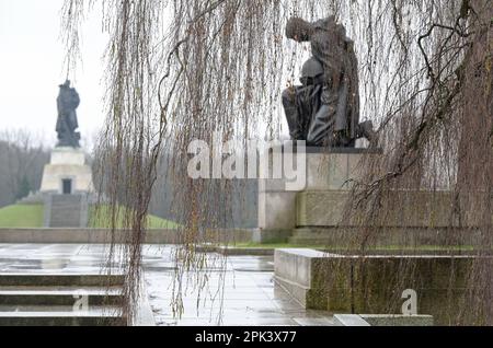 DEUTSCHLAND, ehemals Ost-Berlin, Treptow, sowjetischer Gedenkstein und Soldatenfriedhof mit 7000 Gräbern russischer Soldaten der Roten Armee im Treptower Park, erbaut 1946–49, kniender Soldat mit Pistole und Helm Statue, Heldenverehrung Stockfoto