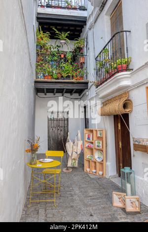 Vejer de la Frontera, Cadiz, Spanien - 02. April 2023 - schöne Ecke mit Balkonen und Fenstern, dekoriert mit Blumentöpfen in Vejer de la Frontera. Stockfoto