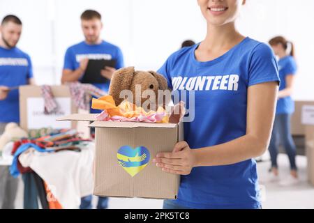 Humanitäre Hilfe für ukrainische Flüchtlinge. Freiwillige-Aufbewahrungsbox mit Spenden im Haus Stockfoto