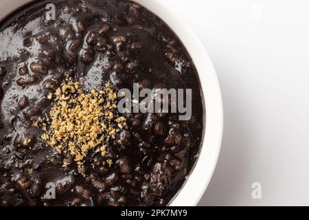 5-körniges schwarzes Sesam Congee auf weißem Hintergrund Stockfoto