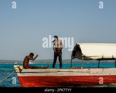 Sansibar, Tansania - Jan, 2021: Boot mit zwei afrikanischen Männern, die auf Prison Island festmachen (auch bekannt als Changuu, Quarantine Island i Kibandiko). Heute bin ich es Stockfoto