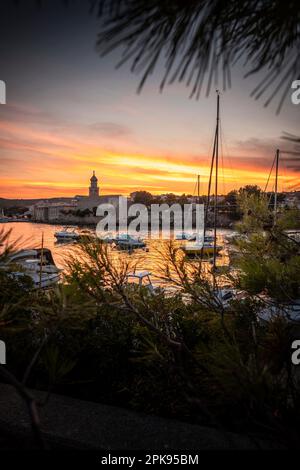 Sonnenuntergang über dem Hafen und der Altstadt von Krk auf der Urlaubsinsel Krk in Kroatien am Mittelmeer Stockfoto