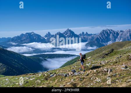 Dobbiaco, Val Pusteria, Provinz Bozen, Südtirol, Italien. Kletterer auf der Dolomiti-Wanderung zwischen dem Dobbiaco Pfannhorn und dem Marchkinkele. Im Hintergrund die Sesto Dolomiten mit den Three Peaks. Stockfoto