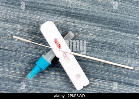 Nasaler Selbsttest Covid 19, Draufsicht auf grauem Hintergrund. Stockfoto