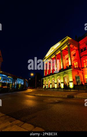 Breslau, Polen - Juni 2022: Breslau-Oper an einem dunklen Sommerabend mit farbigen Lichtern in Gelb und Rot beleuchtet Stockfoto