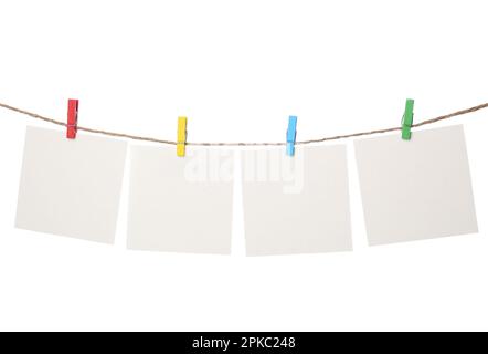 Kleidung mit leeren Notizbüchern auf Schnur vor weißem Hintergrund. Platz für Text Stockfoto