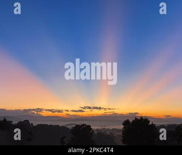 Dramatische und wunderschöne Sonnenstrahlen bei Sonnenaufgang Stockfoto