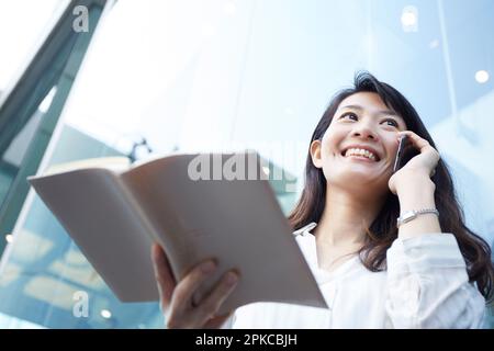 Karrierefrau, die einen Anruf mit offenem Terminkalender tätigt Stockfoto
