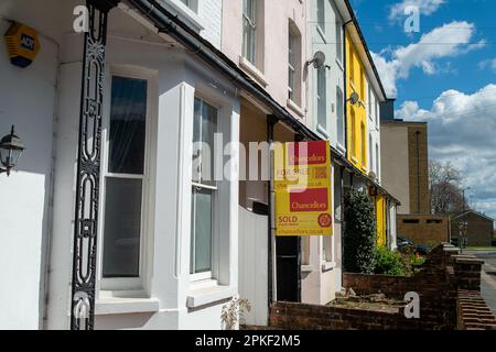 Maidenhead, Berkshire, Großbritannien. 7. April 2023. Ein Verkaufsschild und ein Verkaufsschild an einer hübschen bunten Reihe von bemalten Terrassenhäusern in Maidenhead, Berkshire. Die Building Society Halifax berichtete, dass sich die Wohnimmobilienpreise in den letzten drei Monaten bis Ende März weiterhin leicht erholt haben. Dies ist trotz der steigenden Lebenshaltungskosten der Fall. Kredit: Maureen McLean/Alamy Live News Stockfoto