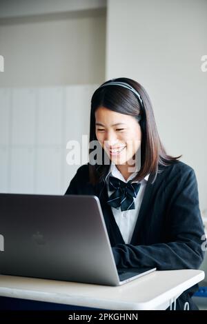 Highschool-Mädchen bedienen einen Computer in einem Klassenzimmer Stockfoto