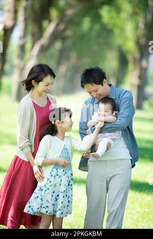 Eine Familie, die sich unter den Pappelbäumen unterhält Stockfoto