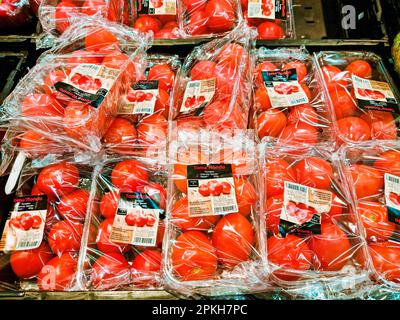 WETZLAR, HESSEN, DEUTSCHLAND 12-21-2022: Frische und saftige Tomaten, verpackt auf einem Verkaufstisch in einem Lebensmittel. Stockfoto