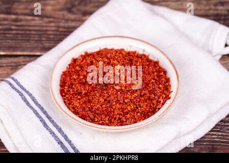 Chilipfeffer ohne Samenflocken. Getrocknete rote Pfefferflocken in der Schüssel. Gewürze und Kräuter. Stockfoto