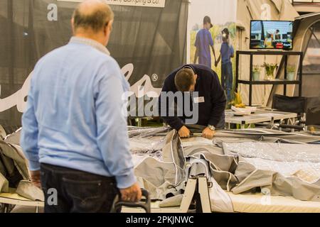 ESSEN, DEUTSCHLAND - 21. FEBRUAR: Am 21. Februar 2018 bereitet ein Aussteller zu Beginn der Reise + Camping-Ausstellung in Essen ein Pop-up-Trailer-Zelt vor Stockfoto