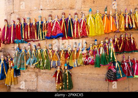 Jaislamer Fort, Rajasthan, Indien - 13.10.2019 : traditioneller König und Königin, Raja Rani genannt, handgefertigte Puppen oder Katputli-Sets hängen an der Wand. Stockfoto