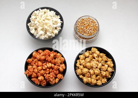 Aromatisiertes Popcorn: Natürlich, mit Chili und Karamell, eine Auswahl an Snacks mit Getränken, die für einen Film bereit sind Stockfoto