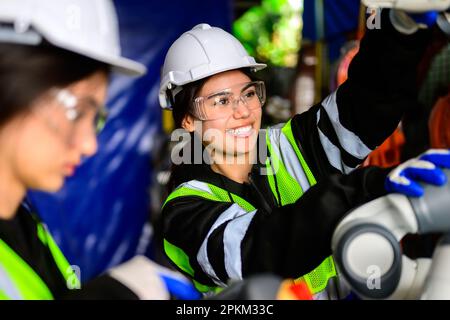 Glückliche Wartungshelferinnen, die in einer Fabrik arbeiten Stockfoto