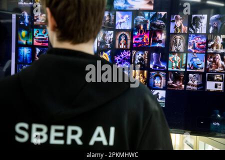 Moskau, Russland. 8. April 2023. Ein junger Mann präsentiert das neuronale Netzwerk Kandinsky 2,1 (künstliche Intelligenz für die Bilderzeugung) auf der internationalen Fachmesse für intellektuelle Literatur „Non/Fiction Spring“ im Messezentrum Gostiny Dvor in Moskau, Russland Stockfoto
