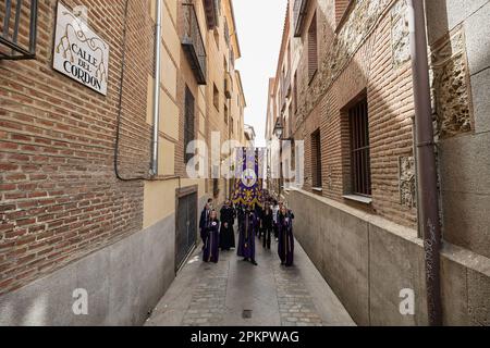 Several people in the procession of a tamborrada heading towards the