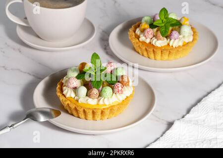 Kleine Käsekuchen mit Süßigkeiten und Schlagsahne Stockfoto