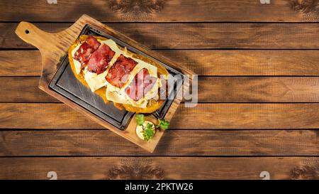 Grüner Plantain Patacon mit gehacktem Huhn, Käse und Speck - kolumbianisches Street Food Stockfoto