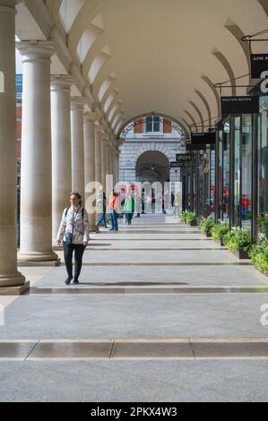 Sehen Sie die Kolonnaden der Geschäfte in der Royal Opera House Arcade auf der Covent Garden Piazza, London, England, Großbritannien Stockfoto