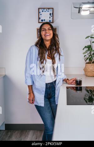Schöne Frau in der Küche mit einer Tasse Kaffee Stockfoto