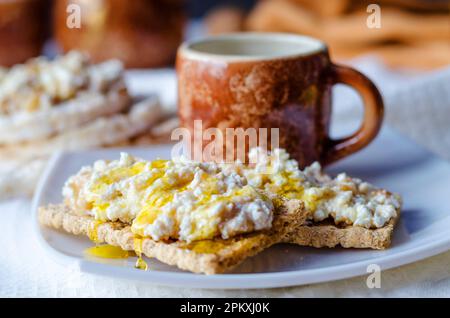 Sandwich mit Hüttenkäse, Honig und Banane auf einem diätetischen Brot. Gesunde Ernährung Stockfoto